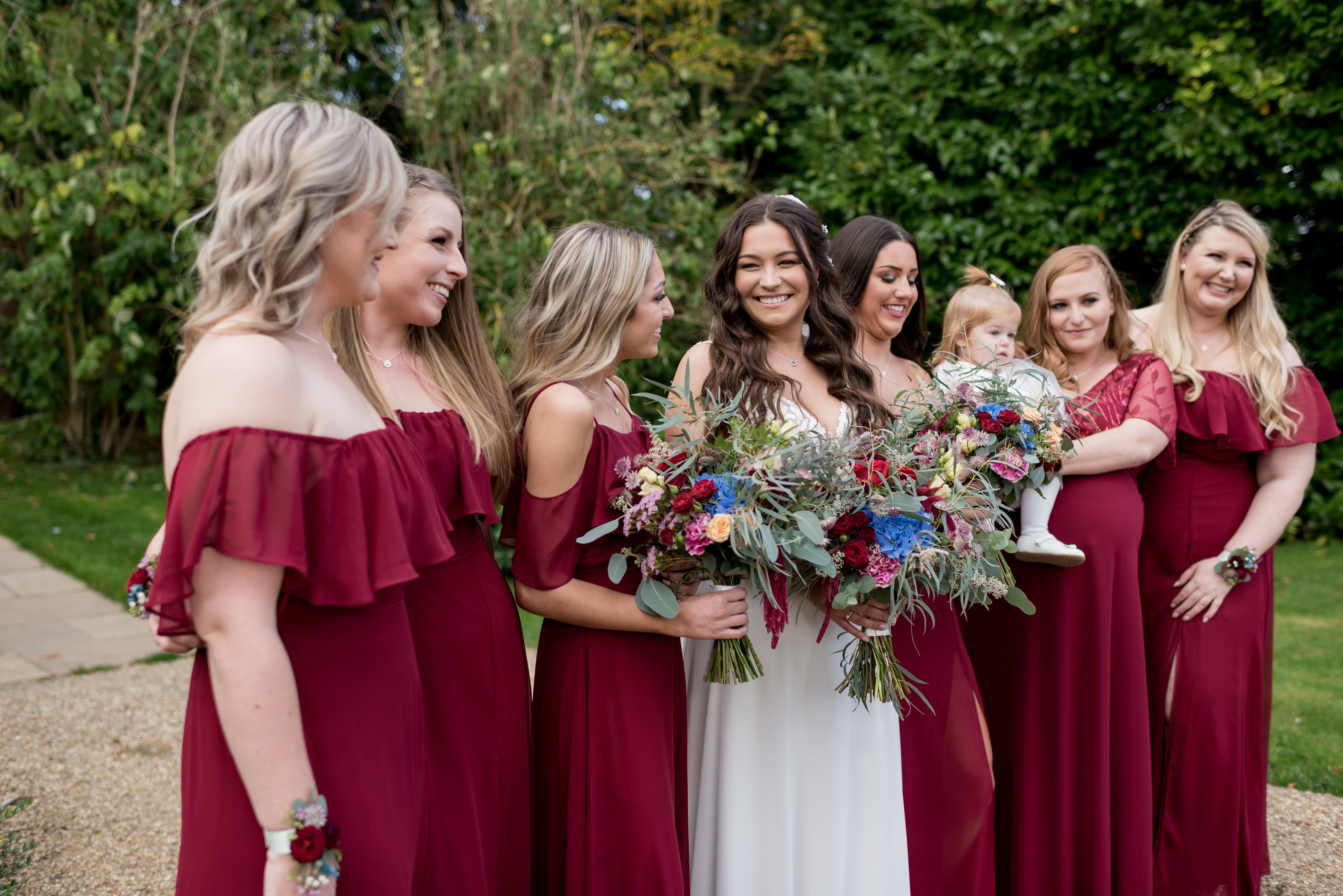 Bride with bridesmaids in a burgundy dress